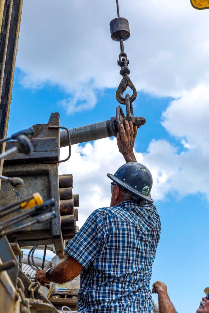 Curt prepares to lift next piece of drilling pipe into place.