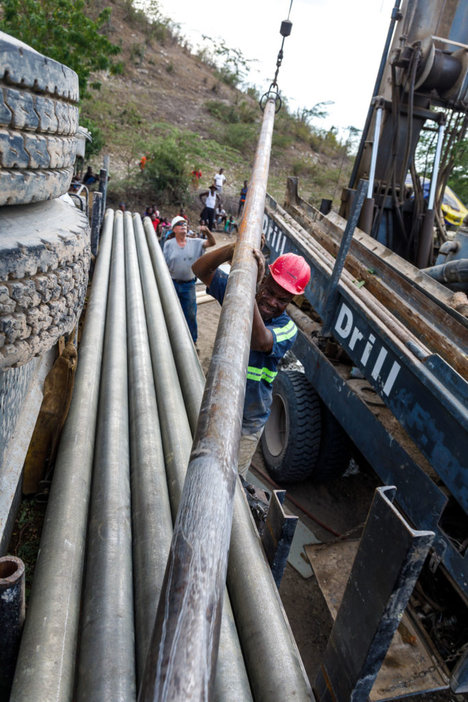 Well drillers pull pipe from a newly dug water well near Terre Blanche, Haiti.
