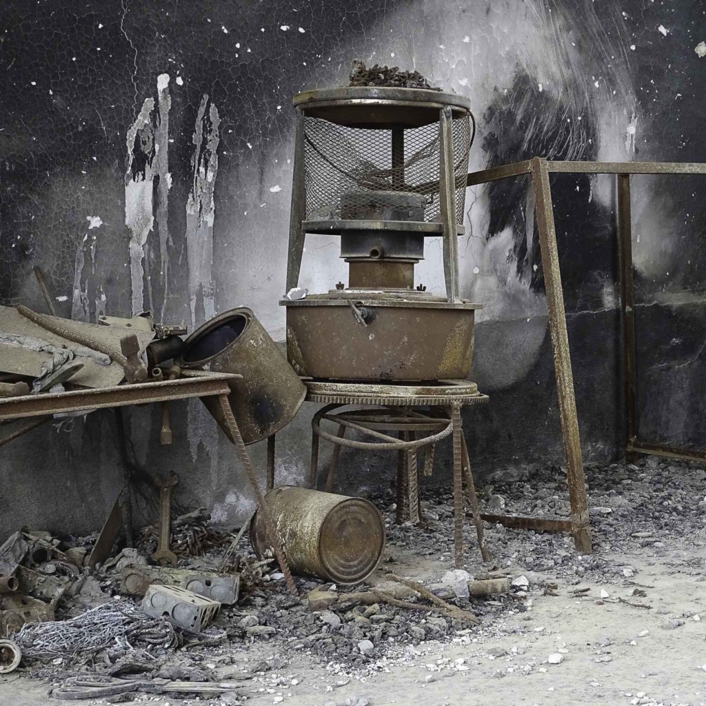 charred remains with metal scraps and old metal frames.
