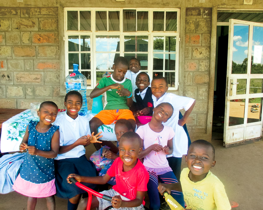 Adopted children smile from the front porch of Family Key's International, Kenya.