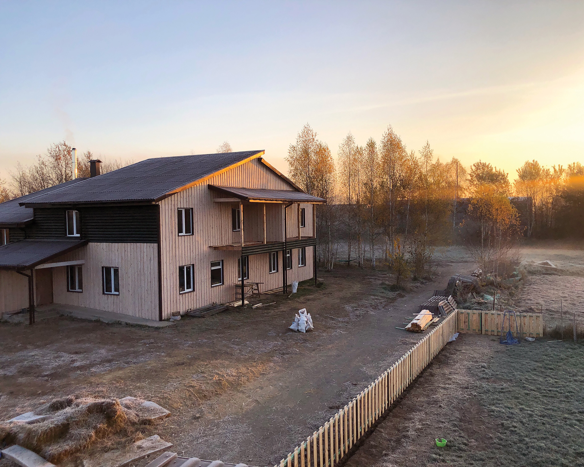 Golden sunrise lighting up a newly built apartment complex in the Ukraine countryside.
