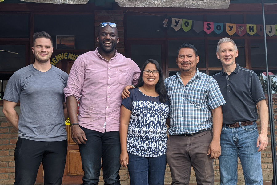 Jordan Stoltzfus, Dan Owolabi, Brian Miller pose with Narlly and her husband in front of the school in Nicaragua.
