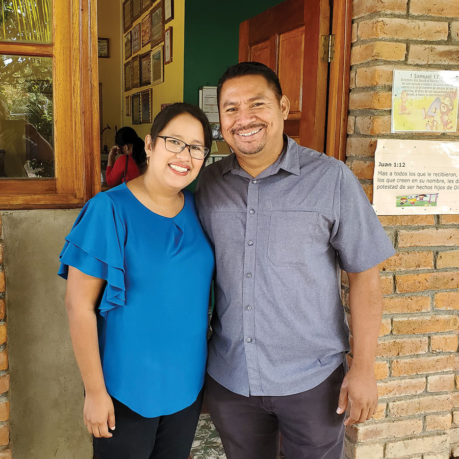 Narlly and her husband pose outside the Christian School in Nicaragua.