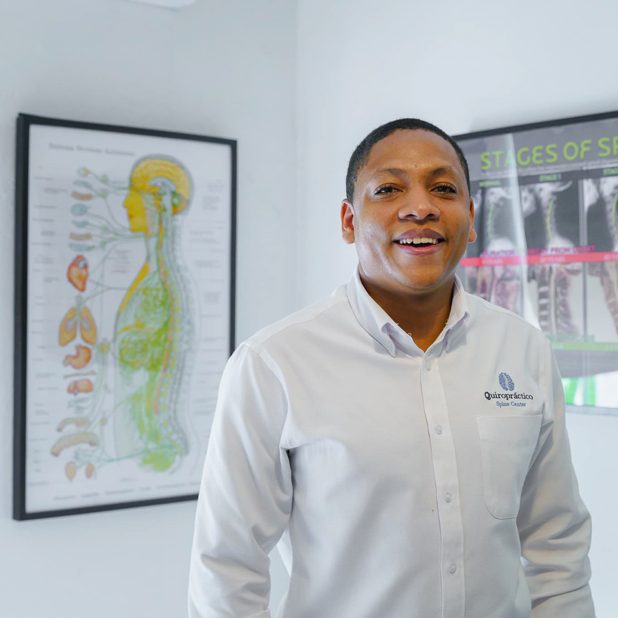 William Ventura, smiling in his chiropractic clinic in the Dominican Republic.
