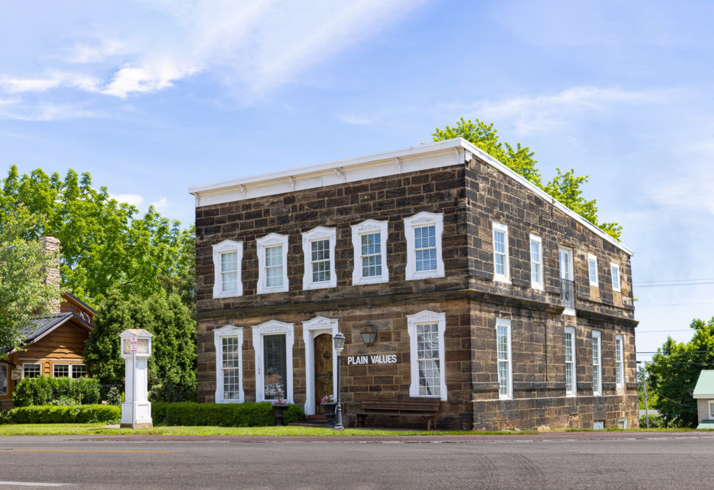 A historic stone building from the 1840's with white wooden trim.