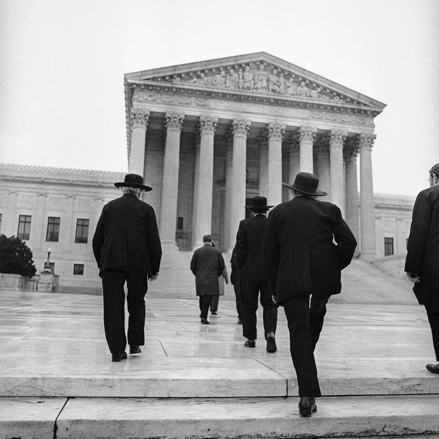 Black and White film image of Amish men walking up steps toward Supreme Court, Washington D.C..