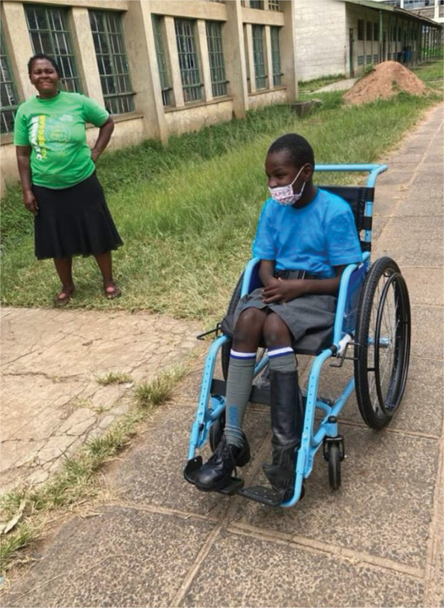 Brighton sitting in his blue wheelchair