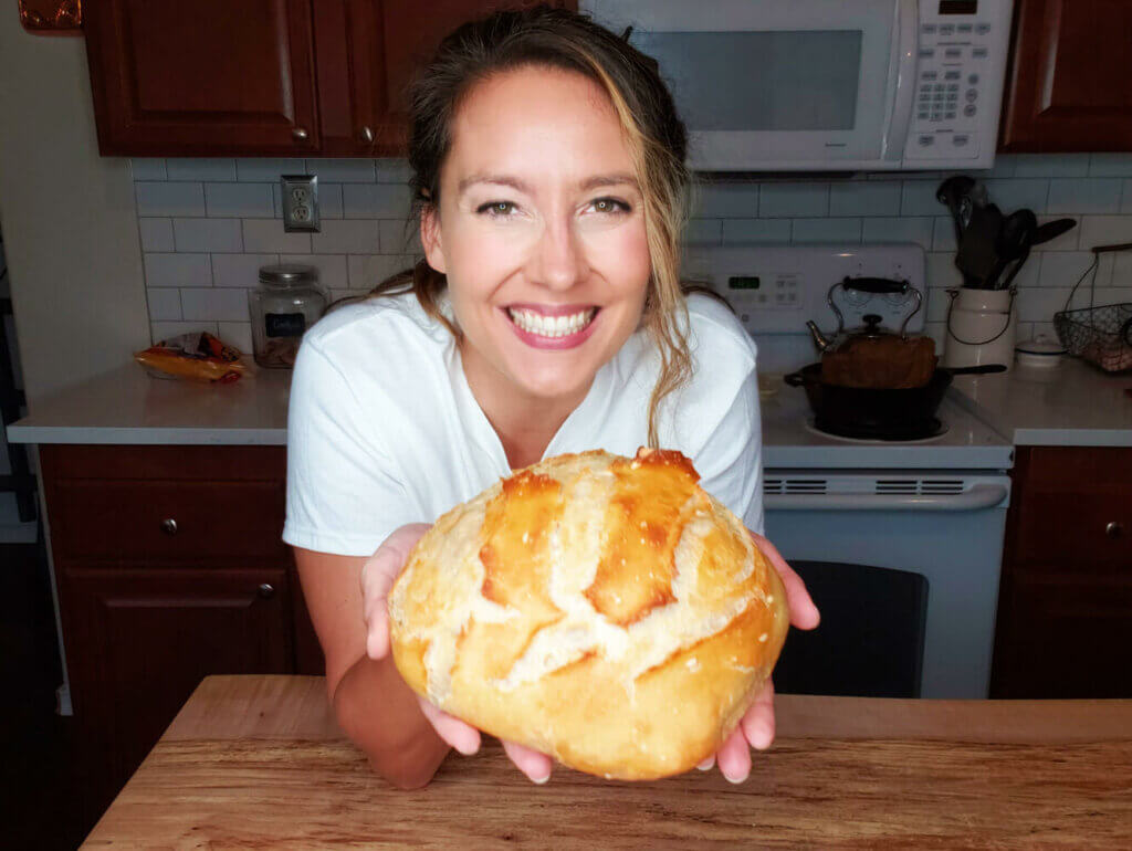 Melissa holding a freshly baked sourdough loaf